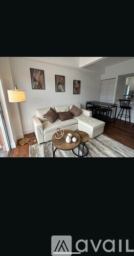 A living room with a white couch and a coffee table.