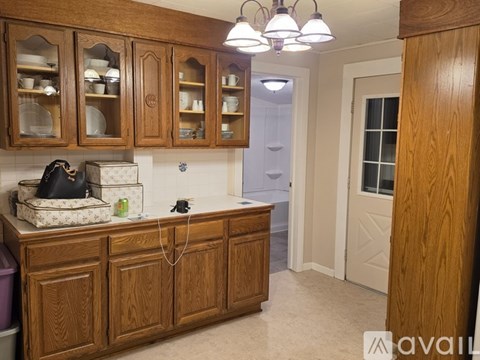 A kitchen with wooden cabinets and a black bag on the counter.