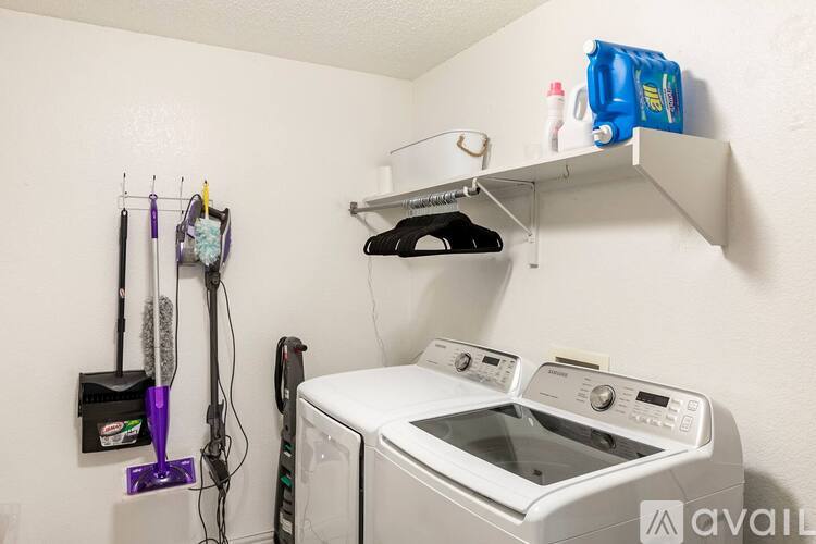 A white washing machine and dryer in a small laundry room.