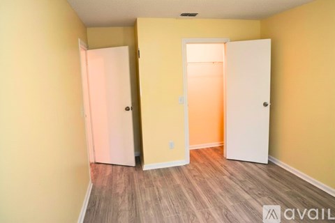 A room with two doors and a wooden floor.