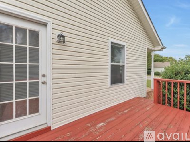A house with a red deck and a white door.