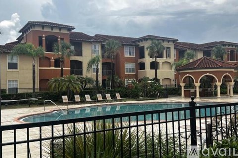 A row of houses with a pool in front.