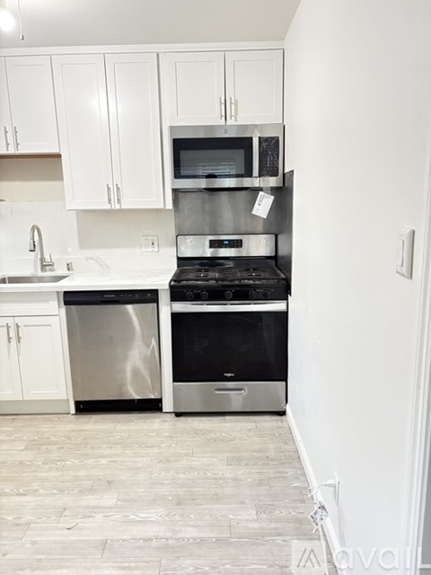 A kitchen with a stove top oven and microwave above a dishwasher.