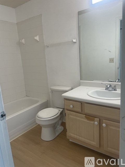 A white toilet sits next to a sink in a bathroom.
