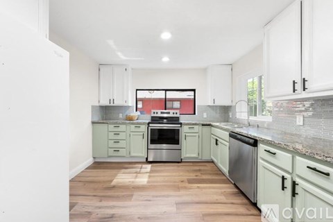 A kitchen with a stove top oven and a dishwasher.