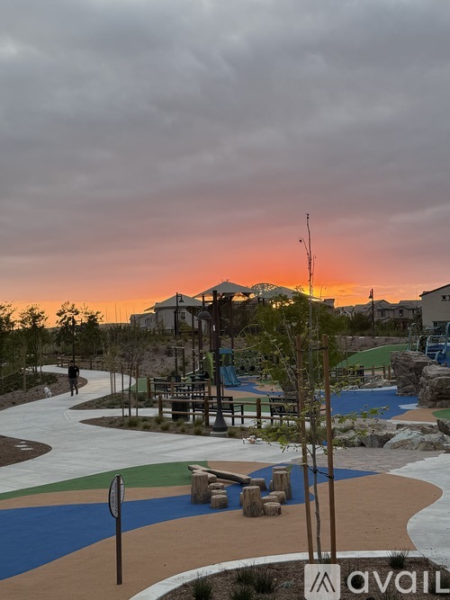 A park with a walking path and a playground.