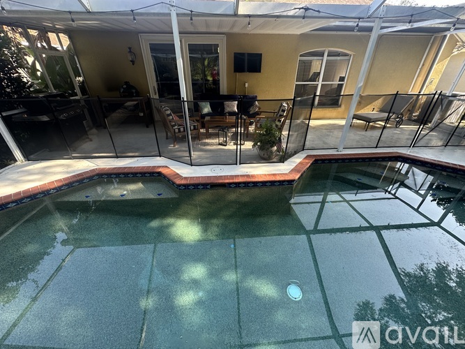 A pool with a glass fence surrounding it.