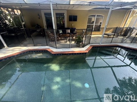 A pool with a glass fence surrounding it.