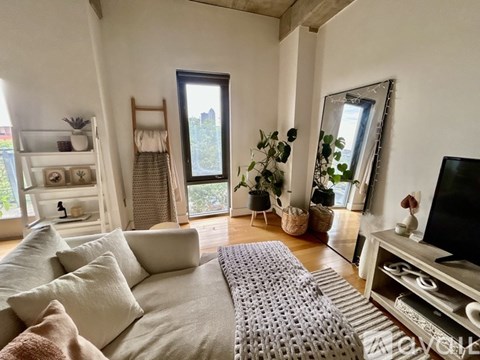 A living room with a grey sofa and a television.