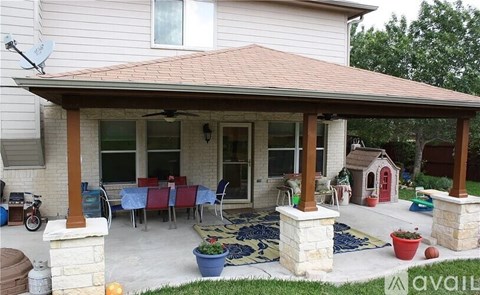 A covered patio area with a table set for dining.