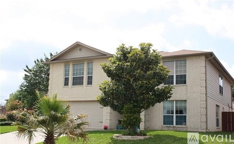 A house with a tree in front of it.