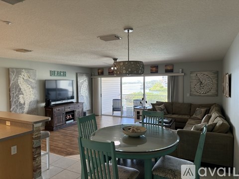 A living room with a dining table and chairs.