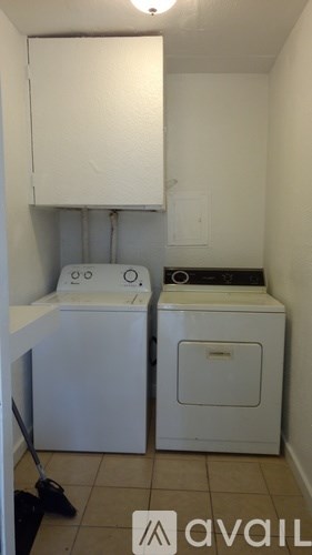 A small laundry room with a washer and dryer.