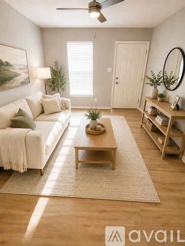 A living room with a white couch, wooden coffee table, and a ceiling fan.