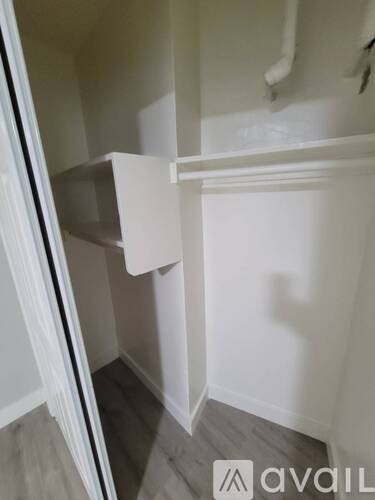 A white bathroom with a toilet and sink.