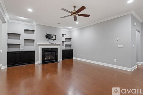 A living room with a fireplace and a television.