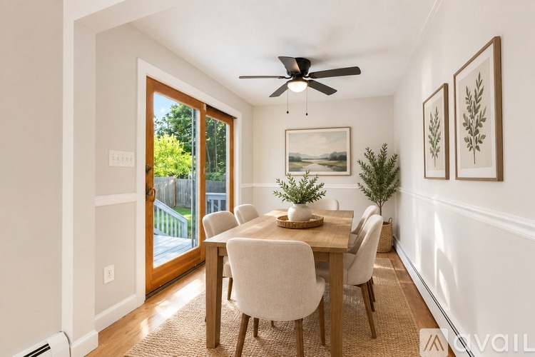 A dining room with a table set for four.