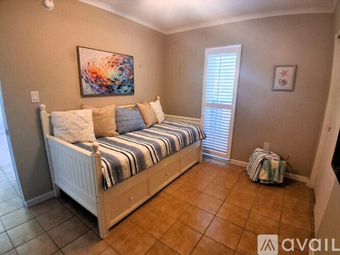 A bedroom with a bed and a painting on the wall.