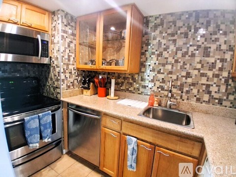 A kitchen with wooden cabinets and a black oven.