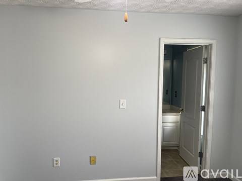 A room with a doorway leading to another room.