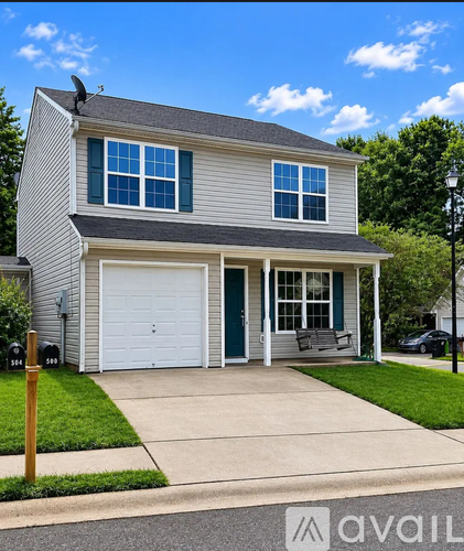 A two-story house with a garage and a driveway.