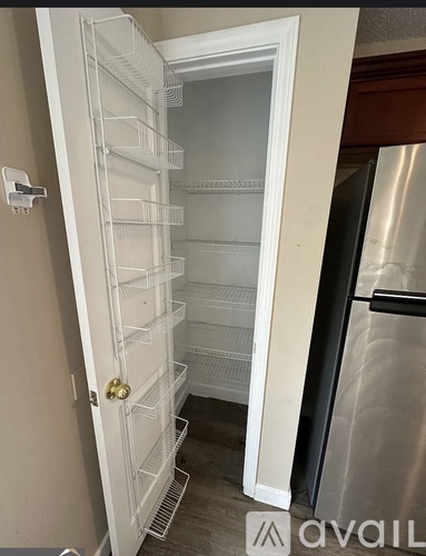 A white refrigerator with its door open in a kitchen.