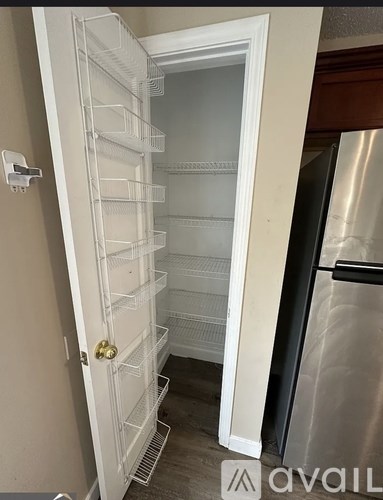 A white refrigerator with its door open in a kitchen.