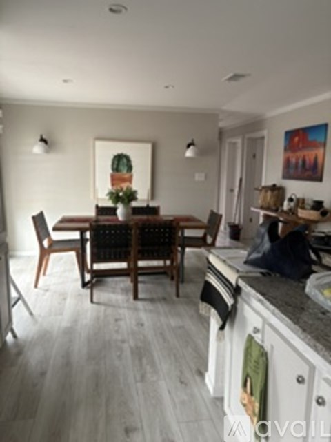 A kitchen with a table and chairs.