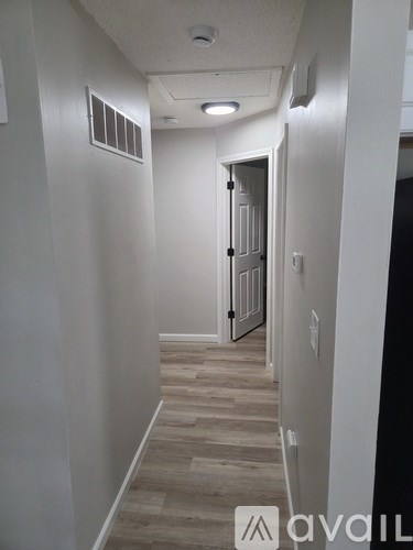 A hallway with a door at the end.