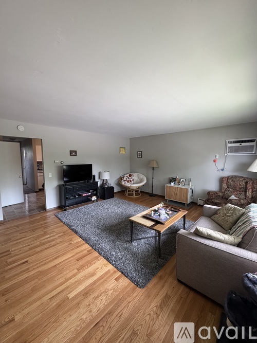 A living room with a grey couch and a coffee table.