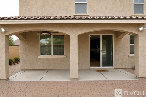 A house with a beige exterior and a tiled roof.