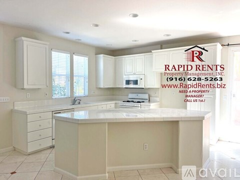 A kitchen with Rapid Rents Property Management Inc sign on the wall.