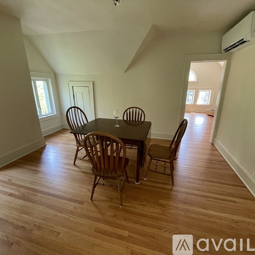 A dining room with a table and chairs.