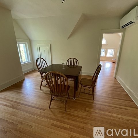 A dining room with a table and chairs.