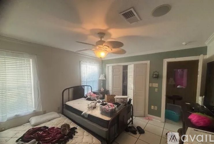 A bedroom with a bed, dresser, and mirror.