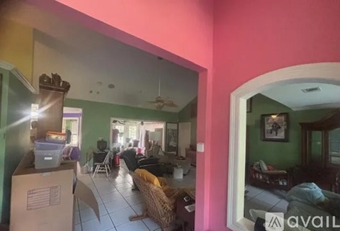 A living room with a couch and a television.