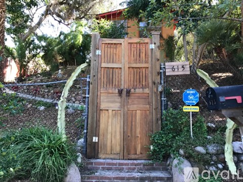 A wooden gate with a sign that says "No Trespassing" in front of it.