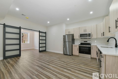 A kitchen with wooden floors and a white counter top.