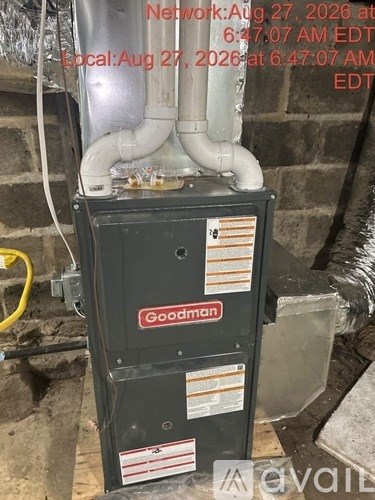A Goodman air conditioning unit is installed on the side of a building.