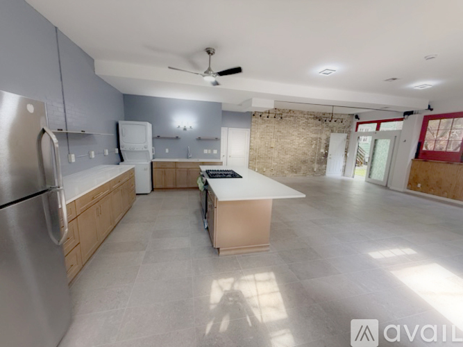 A kitchen with a refrigerator, a stove, and a countertop.