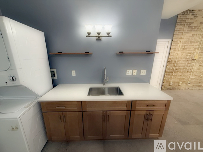 A kitchen with a white dishwasher and a white refrigerator.