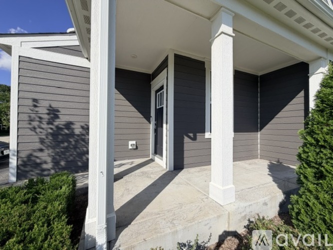 A house with a front porch and a covered entryway.