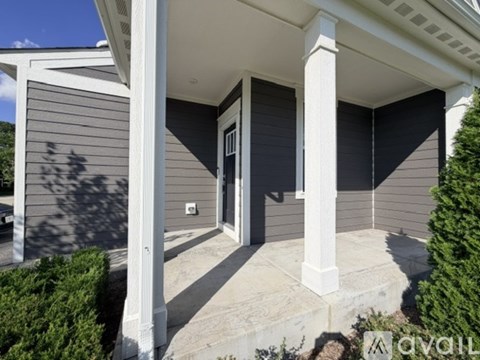 A house with a front porch and a covered entryway.