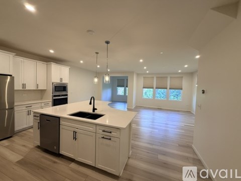 A modern kitchen with white cabinets and a central island.