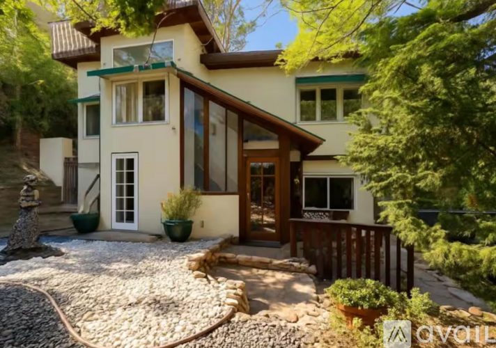 A house with a front yard and a stone pathway leading to the entrance.