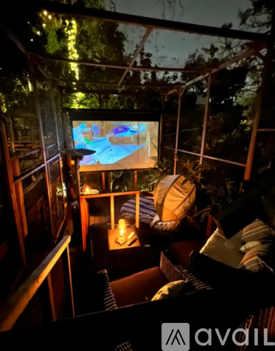 A room with a television and a chair.