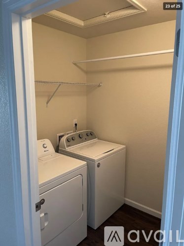 A small laundry room with a washer and dryer.