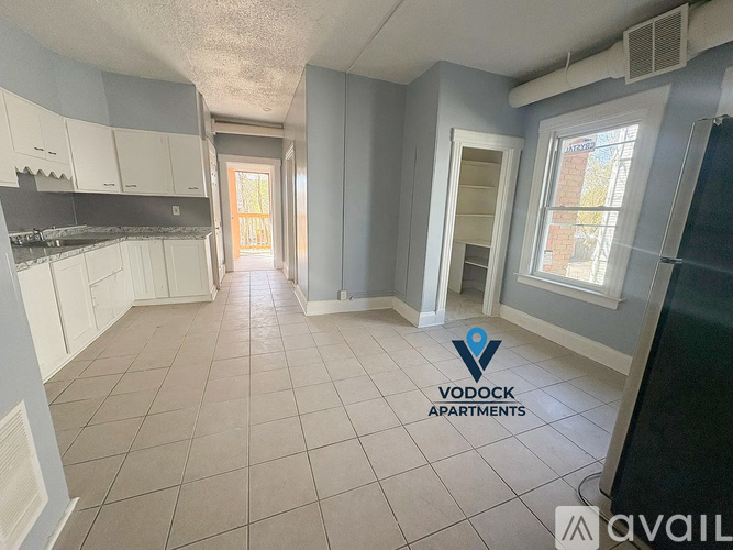 A spacious apartment with a kitchen area is available for rent.