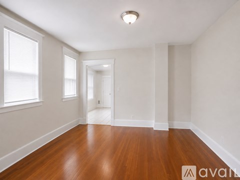 A room with wooden floors and white walls.