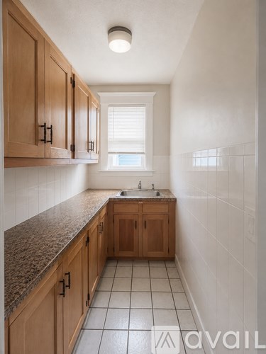 A bathroom with wooden cabinets and a tiled floor.